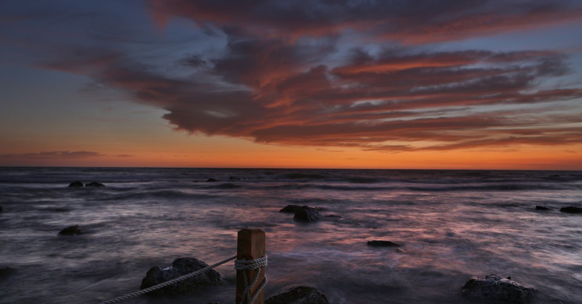 Stunning sunset over the Adriatic Sea with vibrant clouds in Durrës, Albania.