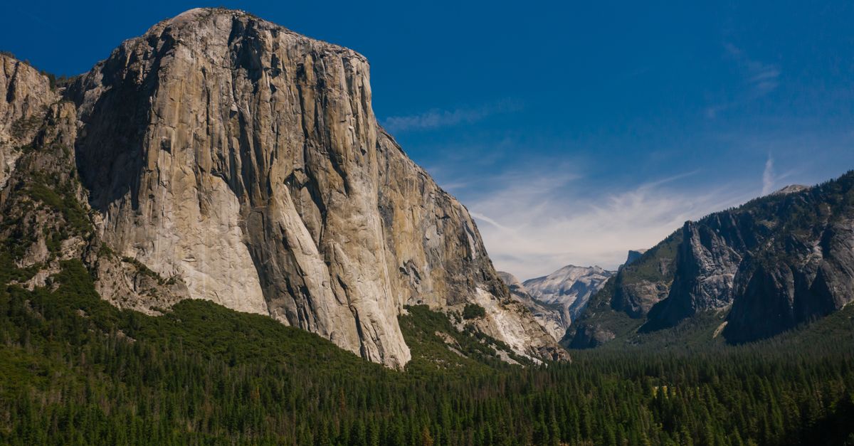 Stunning view of El Capitan, a famous rock formation in Yosemite National Park, under blue skies.