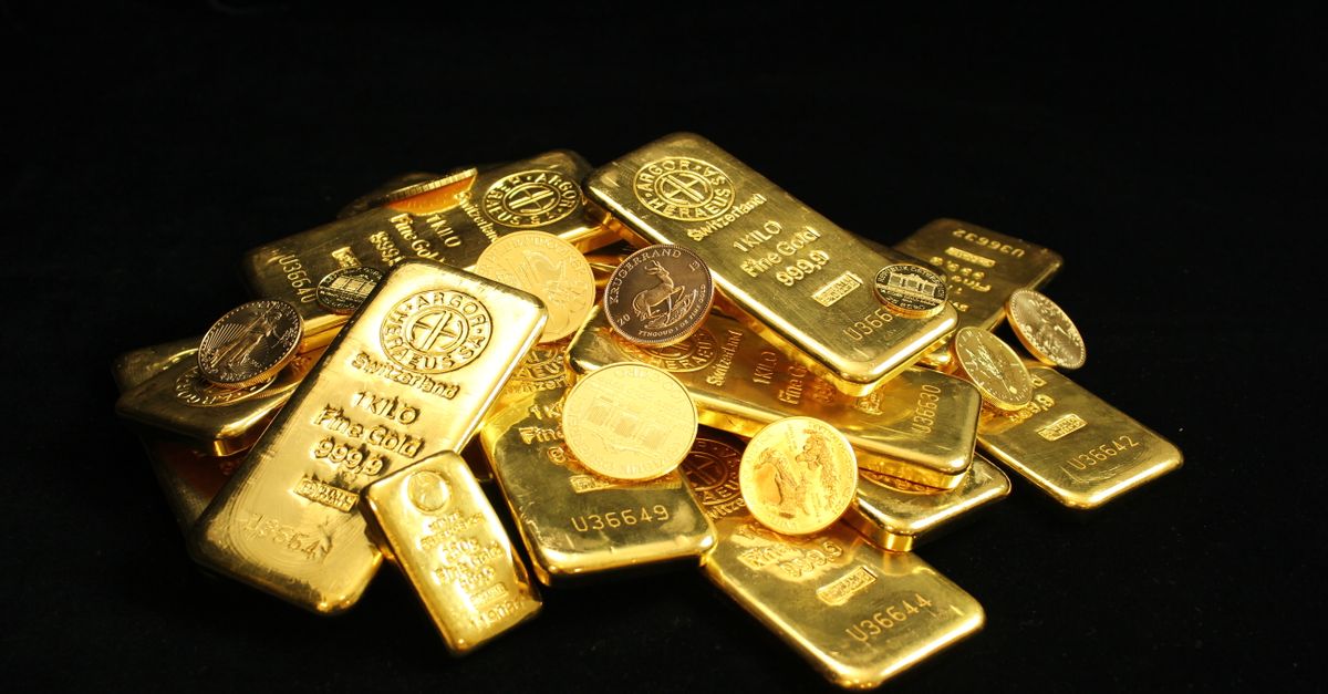 Close-up of shiny gold bars and coins symbolizing wealth and prosperity.