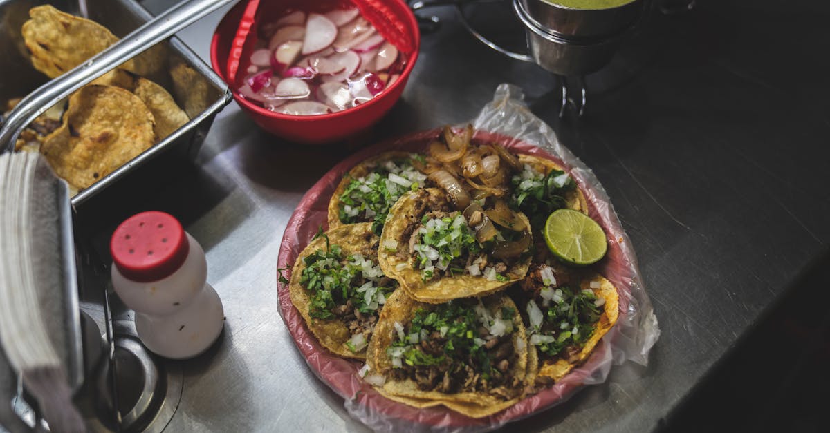 Delicious Mexican tacos with fresh toppings and sauces on a street food stall.