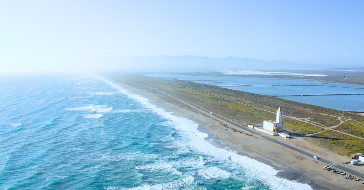 Scenic aerial view of Almería coast, featuring waves and clear blue skies along the Spanish coastline.
