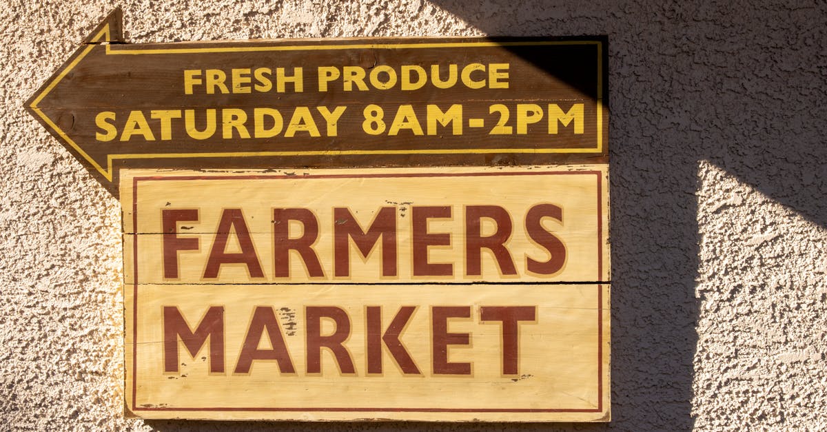 Brightly painted farmers market sign indicating fresh produce times.